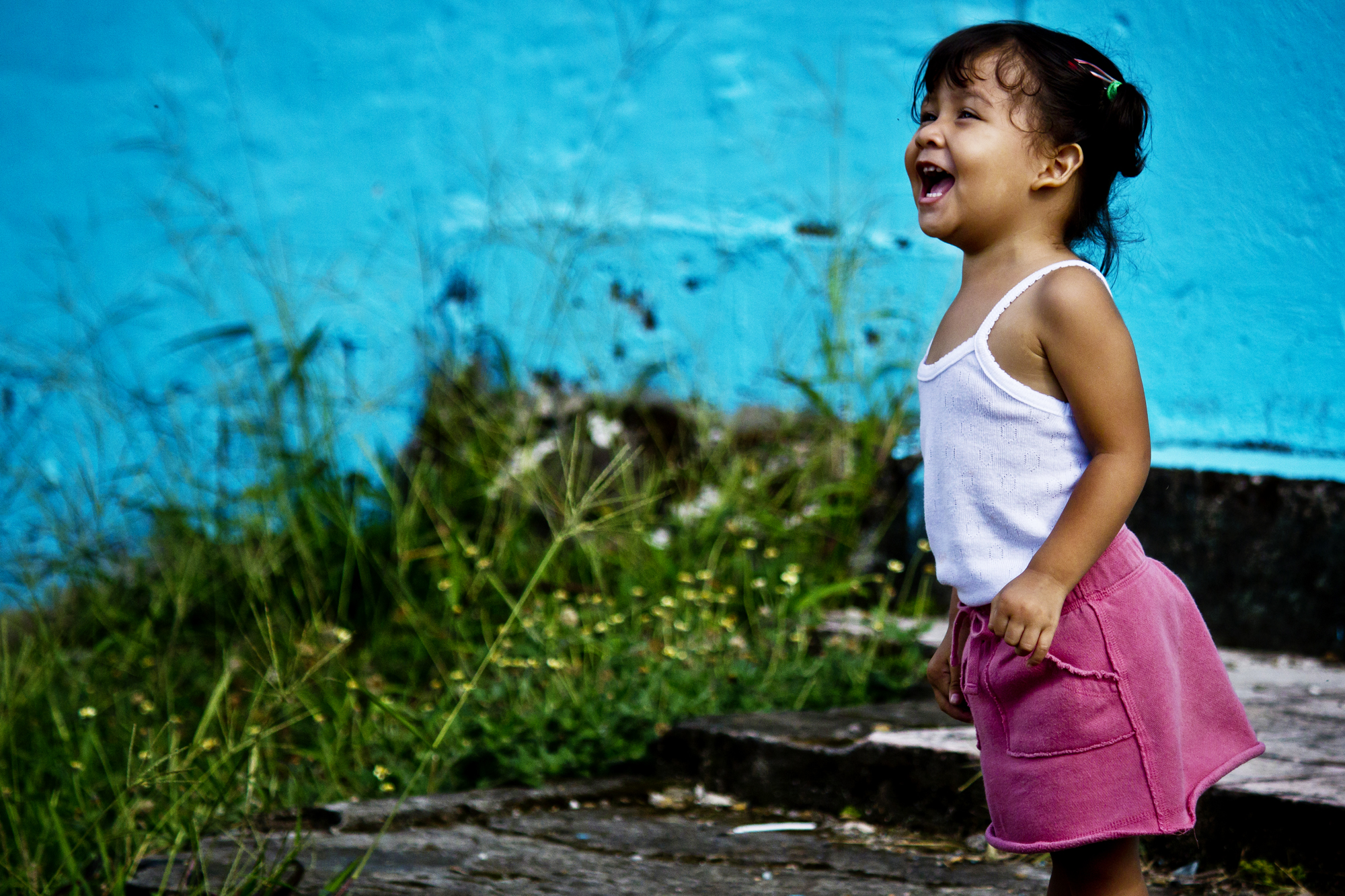 Happy child infront of blue wall